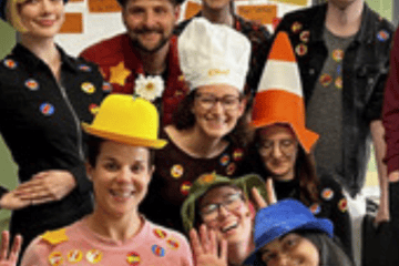 Engaged young people wearing colourful hats and badges, promoting youth involvement and participatio.