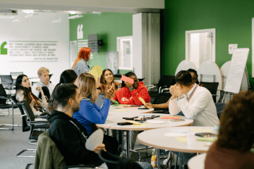 Group of young people engaging in a discussion during a youth empowerment workshop.