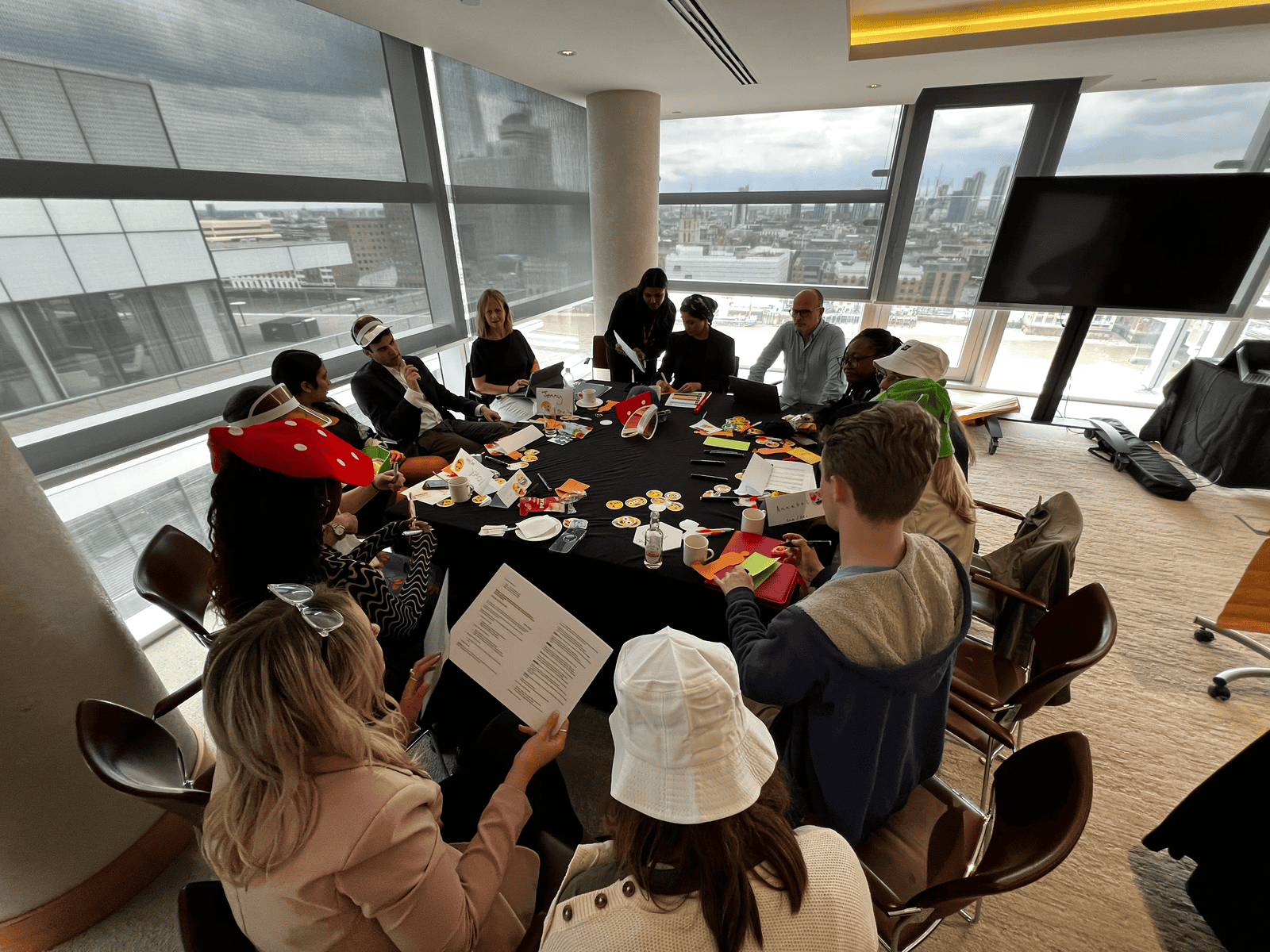 Group of young people and facilitators engaging in a workshop on connectivity in a modern office.