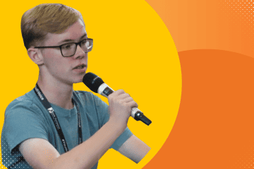 Young person speaking into microphone at a political participation event.