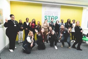 Group of diverse young people and facilitators at youth leadership event.