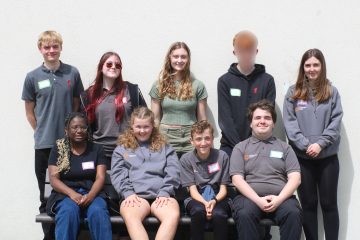 A group of young people stood up - they are the Wiltshire Youth Advisory group