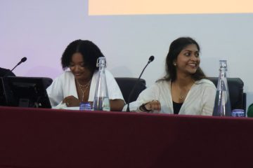 Four young people sat down in front of microphones, hosting a youth-led panel