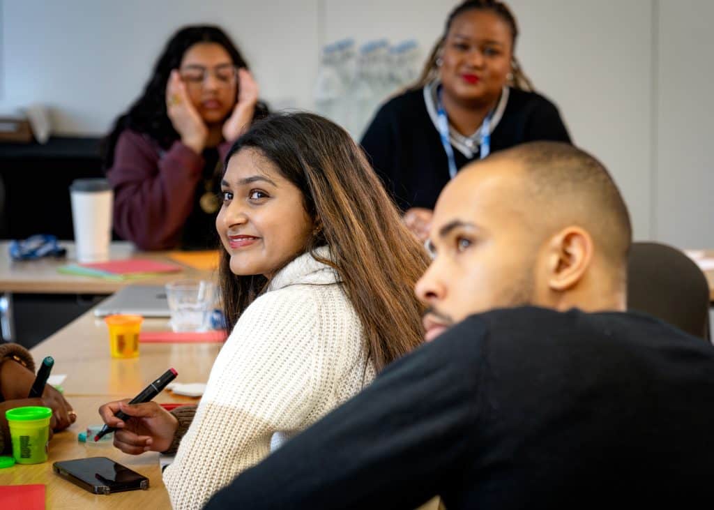Diverse team members engaged in a discussion during a participation workshop.