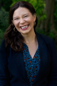 Antonia Dixey smiling outdoors, professional headshot for participation and leadership events.